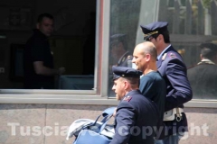 Gli arrestati escono dalla Questura, diretti a Mammagialla