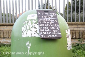 Cartello posizionato da residenti su una campana del vetro
