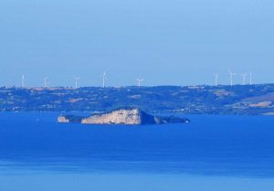 Lago di Bolsena e sullo sfondo, la centrale eolica di Piansano