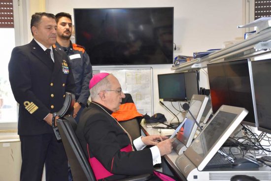 Civitavecchia - Il vescovo Gianrico Ruzza benedice la comunità portuale dalla sala operativa della guardia costiera