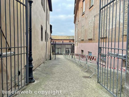 Viterbo - Il muro all'uscita dall'ascensore che porta al duomo pitturato in rosa con tanto di murali e un cartello pubblicitario